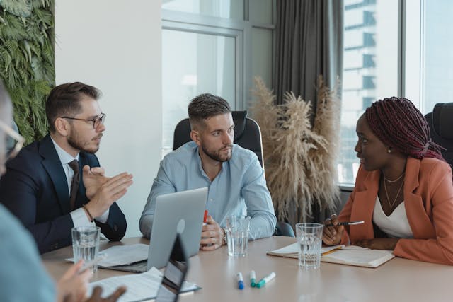 a group of people sitting around a table during a meeting