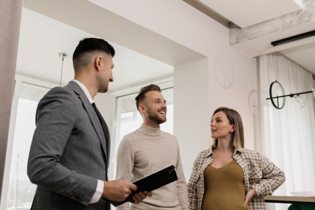 three people viewing a property interior